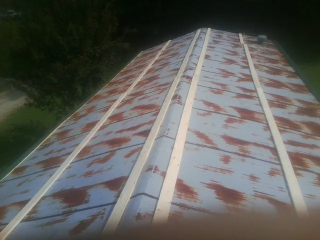 Rusted metal roof panels with new wood purlins before replacement — Storm Damage Roof Repair in Verbena by Roofing Brothers