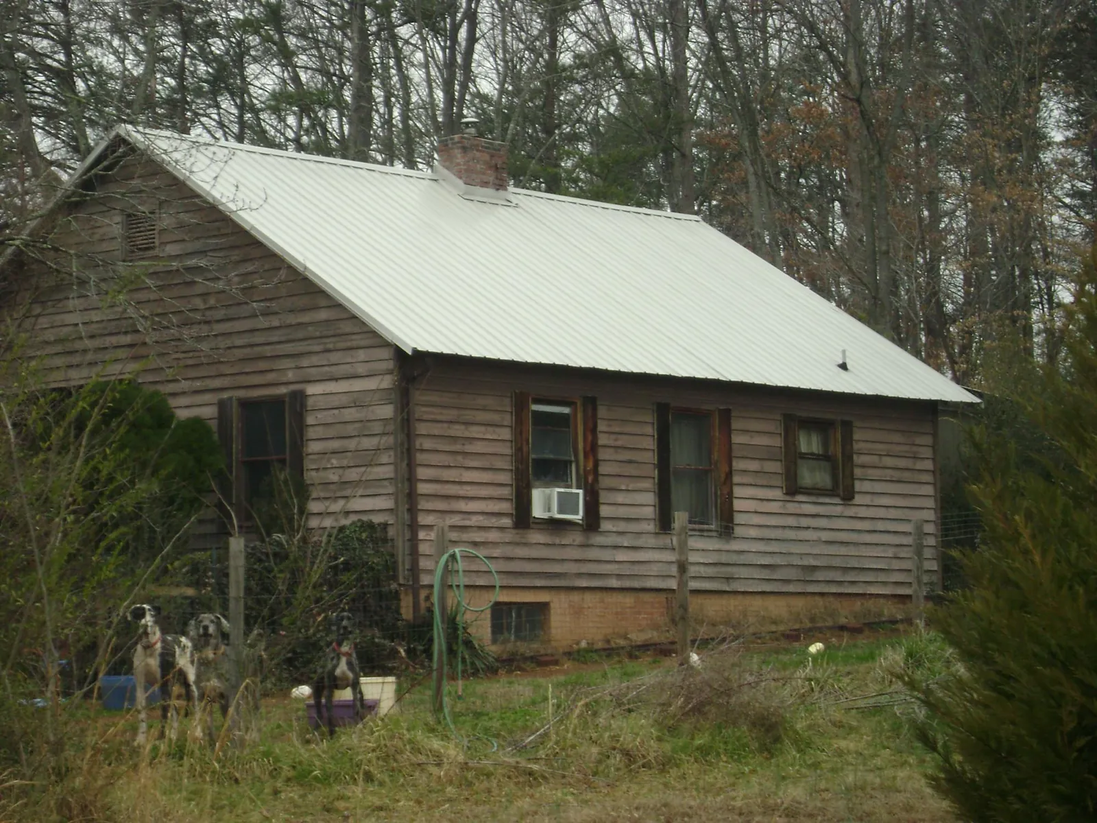 White metal roof on an old wood sided farmhouse, from a Metal Roof Installation job in Verbena
